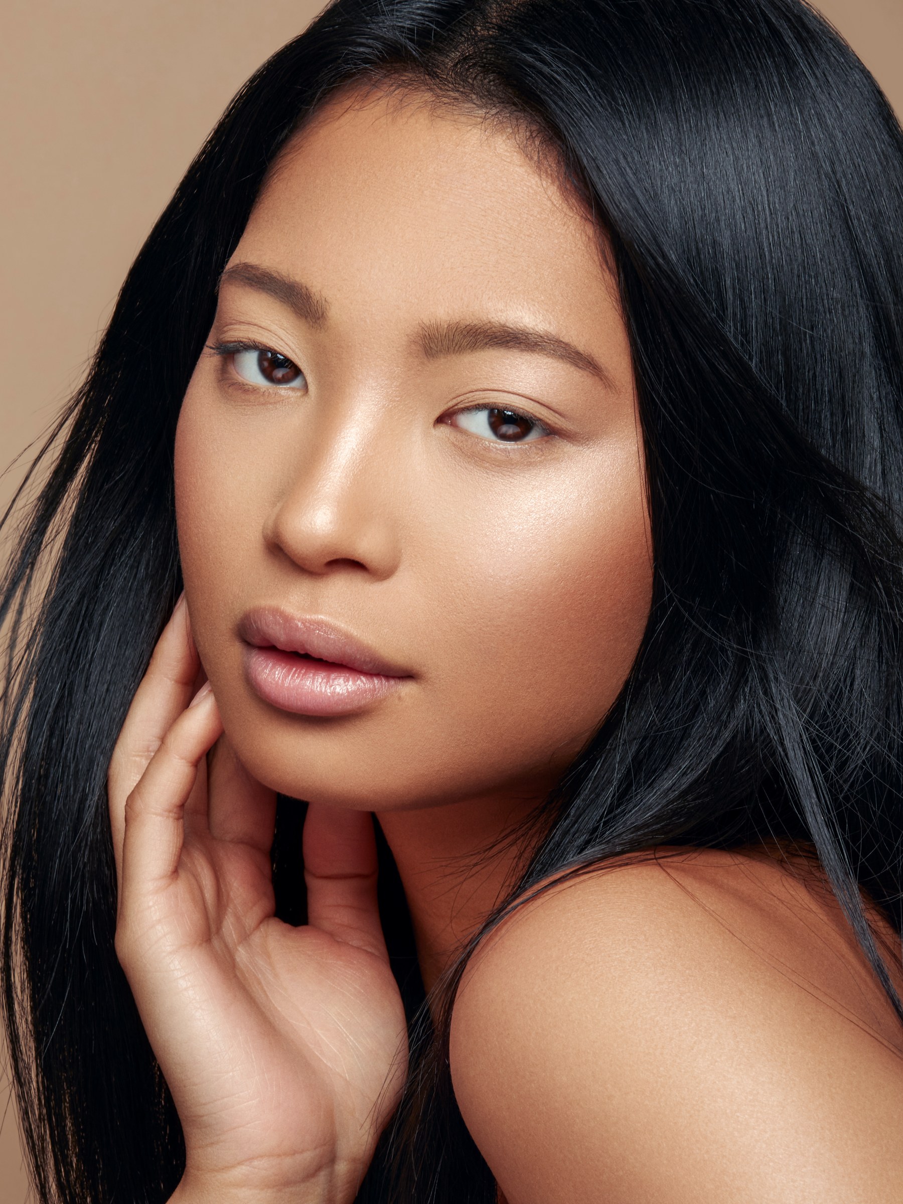 Warm-toned beauty portrait with long dark hair
