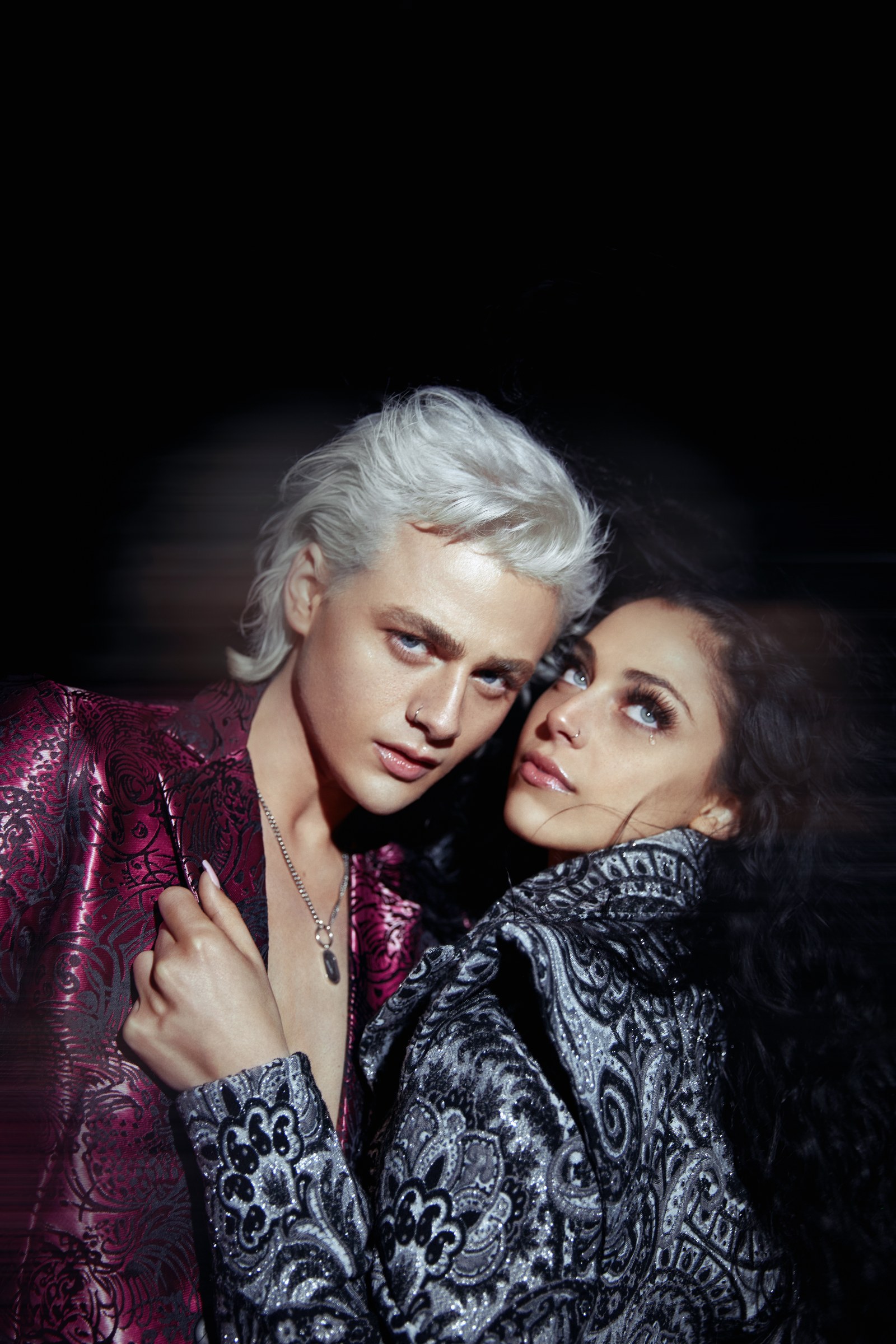 Fashion editorial portrait of two people in embellished tailoring
